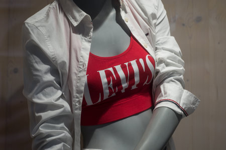Mulhouse - France - 7 June 2020 - Closeup of logo on red tee-shirt by Levi's jeans brand on mannequi in a fashion store showroomのeditorial素材