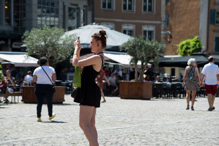 Mulhouse  France - 27 June 2020 - Portrait of tourist taking a photo with his smartphone in the streetのeditorial素材