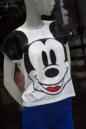 Mulhouse - France - 5 July 2020 - Closeup of stripped swimsuit printed with Mickey mouse by Walt Disney on mannequin in a fashion store showroomのeditorial素材