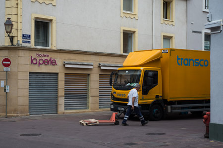 Mulhouse - France - 6 July 2020 - Portrait of delivery man near delivery truck parked in the streetのeditorial素材