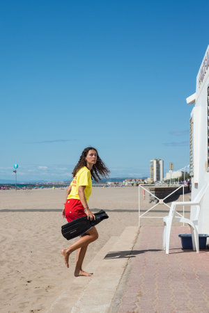 Valras - France - 13 July 2020 - Portrait of lifeguard girl walking on the beachのeditorial素材