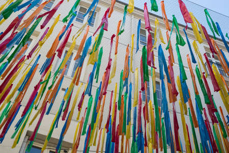 Closeup of colorful piece of plastic ribbon in the street for shadow by summerの写真素材