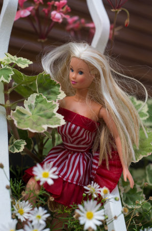 Mulhouse - France - 26 July 2020 - Portrait of Barbie doll standing surrounded by flowers in her gardenのeditorial素材