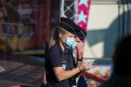 Mulhouse - France - 5 August 2020 - portrait of policewomen patrolling at the fun fair during the covid-19 pandemicのeditorial素材