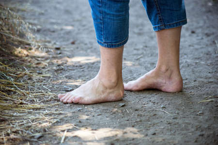 Closeup of barefoot of woman on the landの写真素材