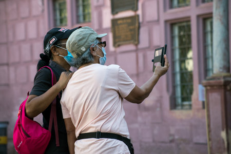 Mulhouse - France - 21 August 2020 - Portrait of tourists taking a photo with her smartphone during...