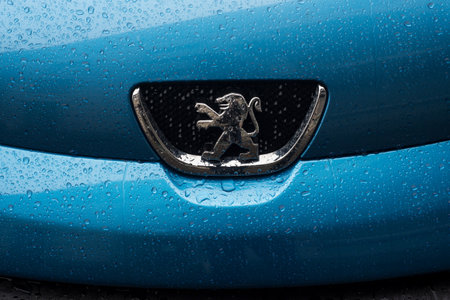 Mulhouse - France - 30 August 2020 - Closeup of rain drops on front car of blue Peugeot 108 parked in the streetのeditorial素材