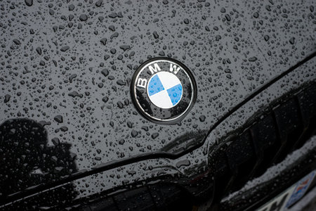 Mulhouse - france - 31 August 2020 - Closeup of rain dropds on BMW sign front of blck car parked in...
