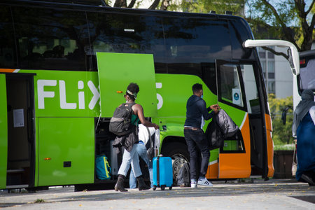 Mulhouse - France - 10 September 2020 - View of the Flixbus departure with people and suitcase in...