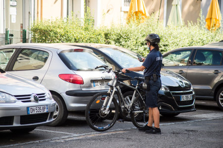 Mulhouse - France - 11 September 2020 - Portrait of policewoman with VTT controlling the parked cars in the streetのeditorial素材