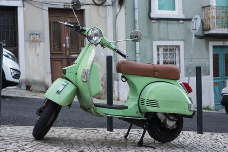 Lisbon - Portugal - 29 September 2020 - View of green vintage vespa scooter parked in the streetのeditorial素材