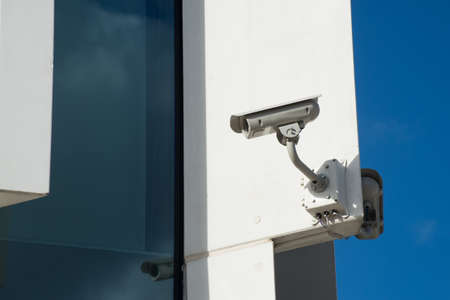 Closeup of security camera on modern building facadeの写真素材