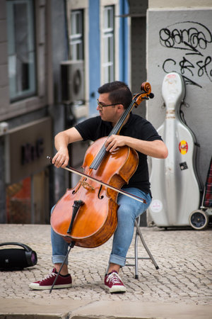 Lisbon - Portugal - 1 October 2020 - Portrait of violoncellist playing in the streetのeditorial素材