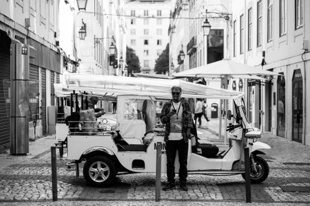 Lisbon - Portugal - 30 September 2020 - Profile view of the traditional tuc tuc vehicle parked in the streetのeditorial素材