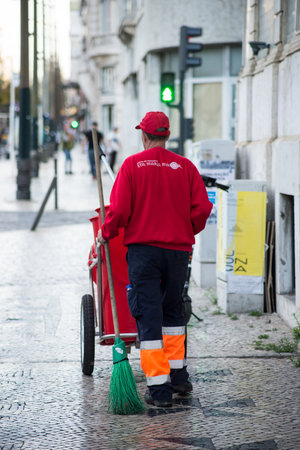 Lisbon - Portugal - 30 September 2020 - Portrait on back view of worker cleaning the streetのeditorial素材