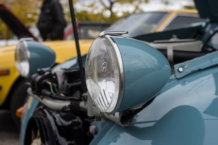 Mulhouse - France - 11 October 2020 - closeup of Front light of blue Citroen 2CV6 parked in the...