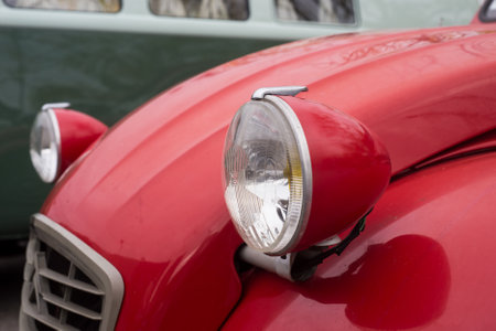 Mulhouse - France - 11 October 2020 - Closeup of Front light of red Citroen 2CV 6 parked in the streetのeditorial素材