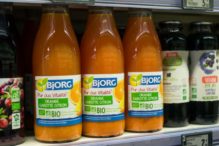 Mulhouse - France - 14 October 2020 - Closeup of natural juice of organic fruits in glass bottles by the famous  brand Bjorg at the supermarketのeditorial素材