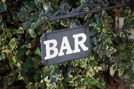 Closeup of BAR signage on green leaves background