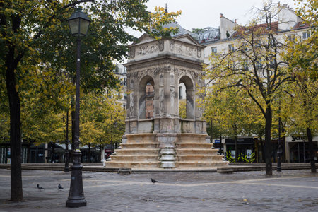 Paris  France - 24 October 2020 - view of stoned fountain on cozy place in chatelet quarterのeditorial素材