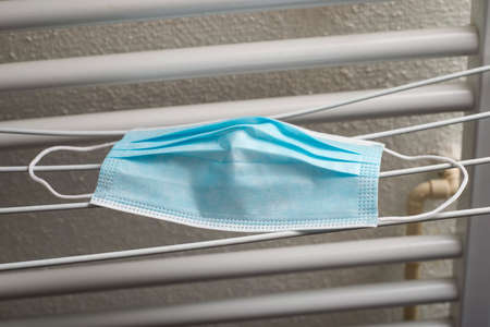 Closeup of medical masks on hanger after washing for recycling during the covid-19 pandemicの写真素材