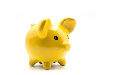 Closeup of yellow piggy bank on white backgroundの写真素材