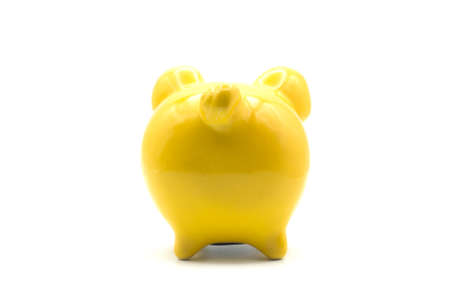 Closeup of yellow piggy bank on back view on white backgroundの写真素材