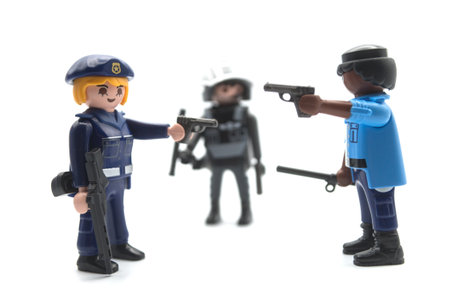 Mulhouse - France - 12 December 2020 - Closeup of playmobil figurines on white background - policemen with uniforms and shotgunsのeditorial素材