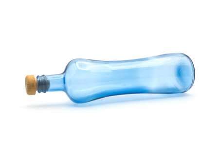 Closeup of blue glass bottle on white backgroundの写真素材