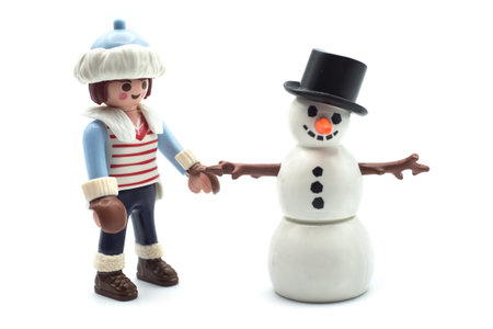 Mulhouse - France - 17 December 2020 - Closeup of playmobil girl figurine and snowman on white backgroundのeditorial素材
