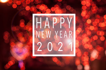 holiday festive glittering defocused red background with bokeh lights - Happy new year 2021 card
