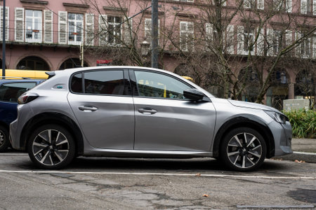 Mulhouse - France - 2 January 2021 - Profile view of grey Peugeot e-208 parked in the streetのeditorial素材