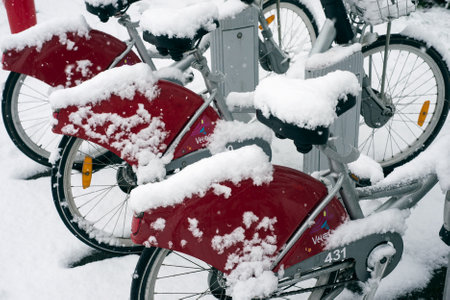 Mulhouse - France - 14 January 2021 - closeup of rental citybike at the  station covered by the snow in the streetのeditorial素材