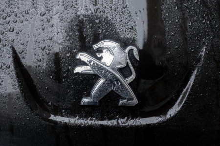Mulhouse - France - 31 January 2021 - Closeyp of rain drops on the lion  logo of black peugeot front car parked in the streetのeditorial素材