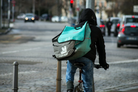Strasbourg - France - 4 February 2021 - Portrait of Delivery man with deleveroo  backpack on a bicycle in the streetのeditorial素材