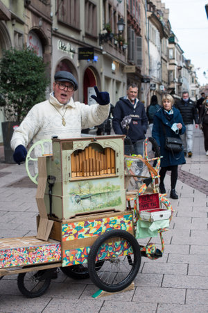 Strasbourg - France - 5 February 2021 - Portrait of man playing with a barrel organ in the streetのeditorial素材