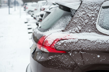Mulhouse - France - 11 February 2021 - Closeup of rear view of Peugeot 2008 covered the snowparked in the street with another cars on backgroundのeditorial素材