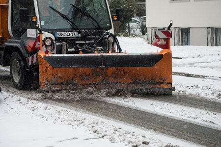 Mulhouse - France - 11 February 2021 - Front View of a snowplow removing the snow on the road by...