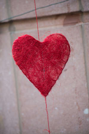 Closeup of decorative heart in front  of traditional store