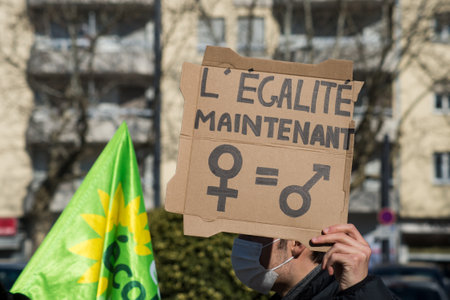 Mulhouse - France - 6 March 2021 - women protesting in the street with gender symbols banner with text "Ã©galitÃ© maintenant" in french, traduction in english : The 
equality nowのeditorial素材