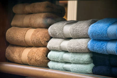 Closeup of colorful bath towels piles in a store showroomの写真素材