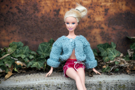 Mulhouse - France - 16 March 2021 - Portrait of Barbie doll with woolen pullover and sexy red short sitting in the streetのeditorial素材