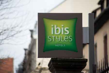 Colmar - France - 14 March 2021 - Closeup of Ibis style logo on signboard of the hotel facade in the streetのeditorial素材