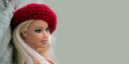 Mulhouse - France - 16 March 2021 - Portrait of blond Barbie doll wearing  a red woolen beret standing in the streetのeditorial素材