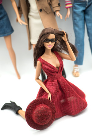Mulhouse - France - 18 March 2021 - Portrait of realist Barbie doll wearing a sexy red dress posing on dolls colection on backgroundのeditorial素材