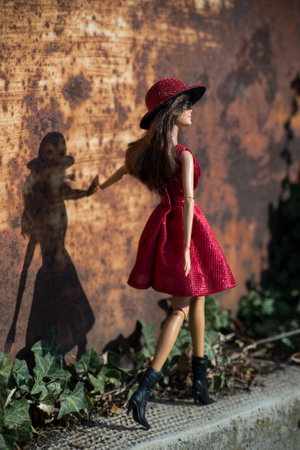 Mulhouse - France - 19 March 2021 - Portrait of Barbie doll wearing a res sexy summer dress and hat standing in the streetのeditorial素材
