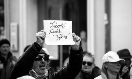 Mulhouse - France - 27 March 2021 -  people  protesting against the sanitary dictatorship  with banner liberte, egalite, verite in french, traduction in english : liberty, equality, truthのeditorial素材