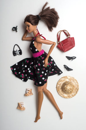 Mulhouse - France - 30 May 2021 - Portrait of brunette barbie doll wearing a black summer dress with accessories on white backgroundのeditorial素材