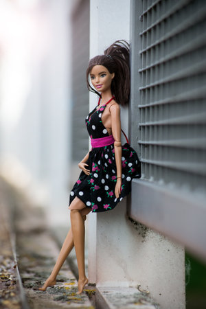 Mulhouse - France - 2 June 2021 - Portrait of brunette barbie doll wearing a black summer dress posing in the streetのeditorial素材