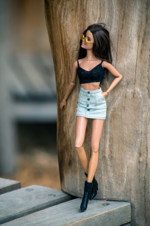 Mulhouse - France - 9 June 2021 - Portrait of brunette barbie doll wearing a mini blue jeans skirt and sexy grey top standing in outdoor  in the streetのeditorial素材